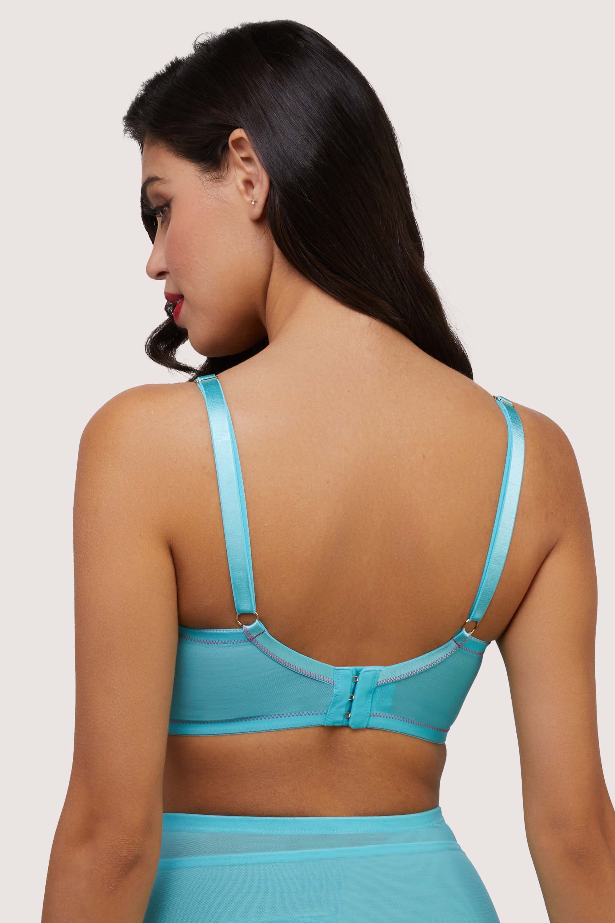 Model shows adjustable shoulder straps and hook and eye fastening back of retro sky blue bullet bra