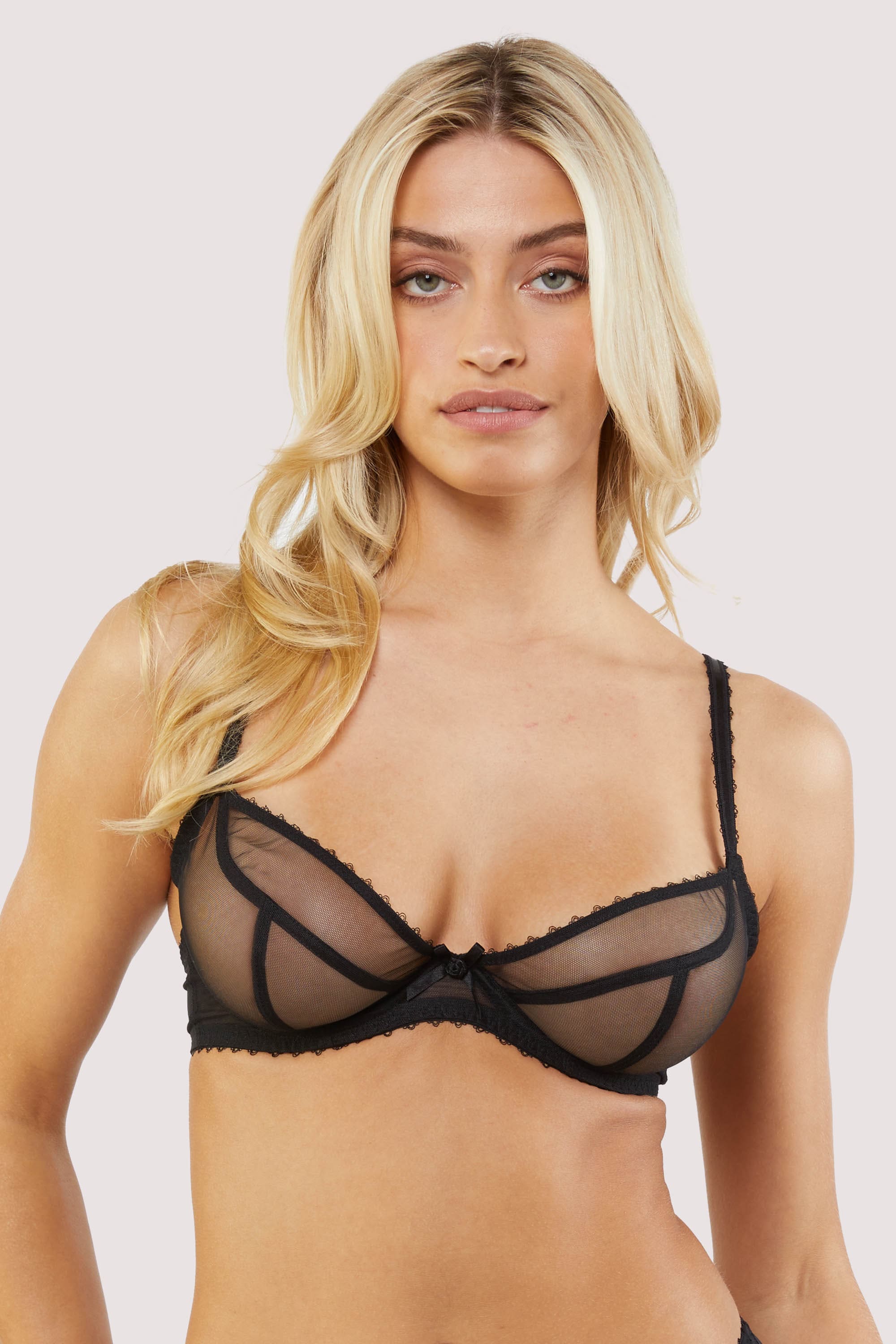 Model Wears Black Mesh Bra with sheer plunge cups, underwire support, and delicate bow detail at the center.