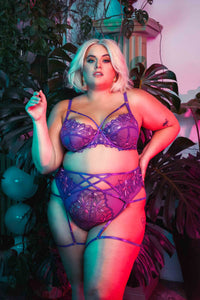4 strap suspender with purple straps over the stomach, hips and thighs, worn with a matching thong and bra by Felicity Hayward.