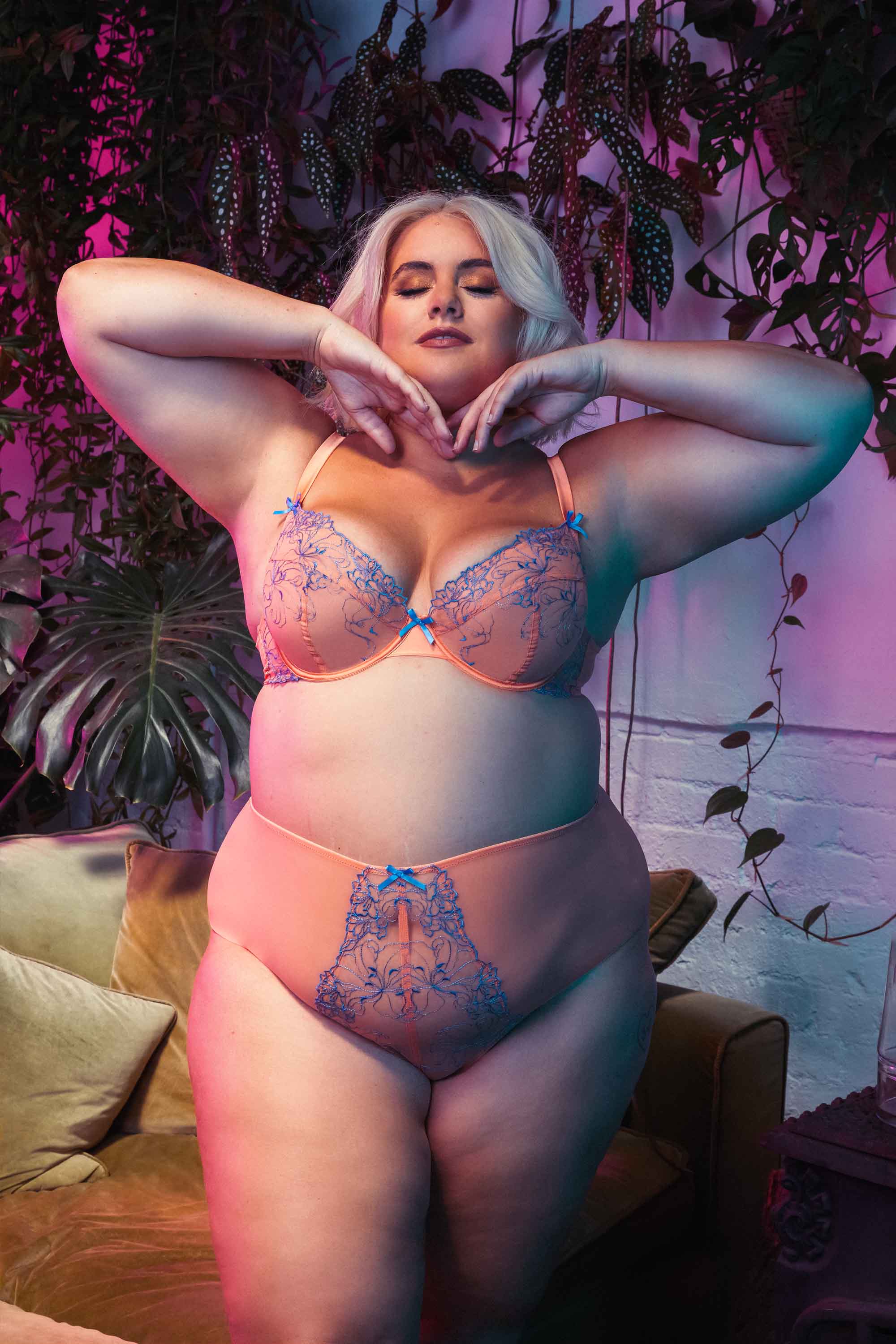 Mesh and lace orange bra and brief set with lilac/blue lace embroidery accents and bows, seen on Felicity Hayward.