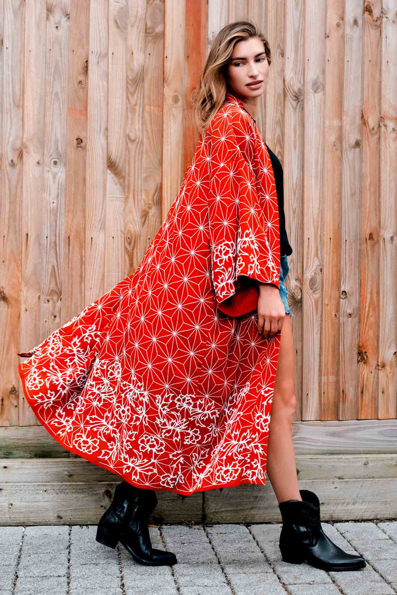 Model styles terracotta kimono robe embroidered with ivory peonies and and asanoha over denim shorts and a black t-shirt