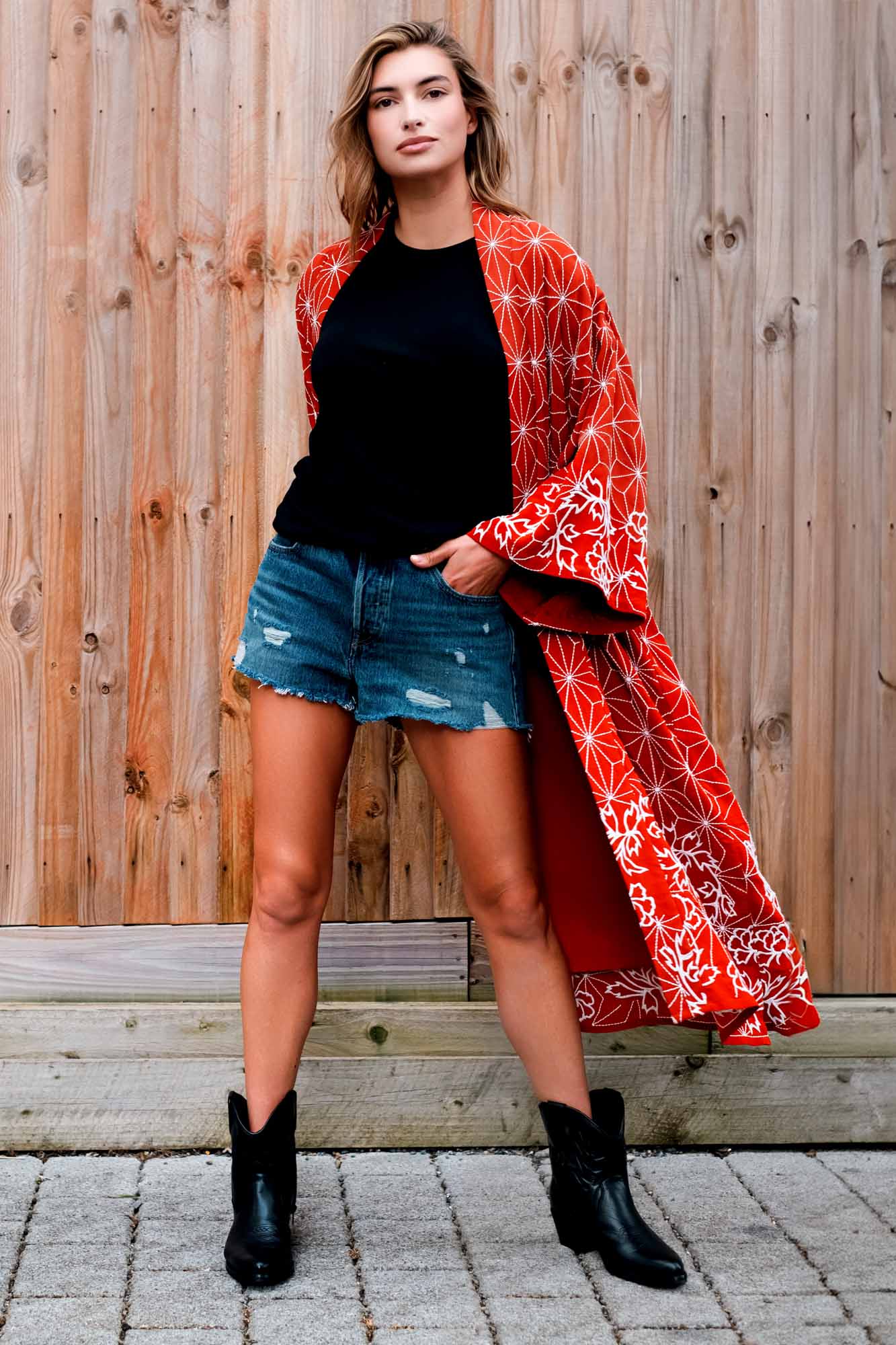 Model styles terracotta kimono robe embroidered with ivory peonies and and asanoha over denim shorts and a black t-shirt