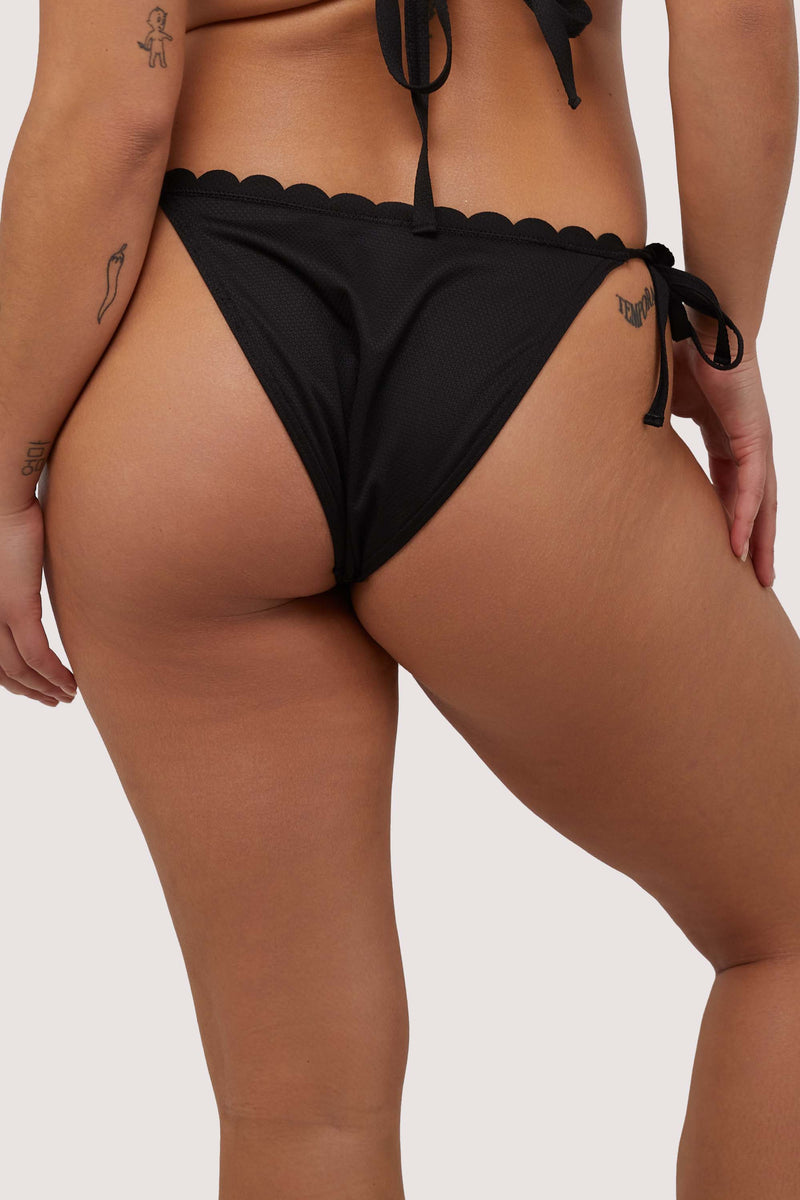 model shows black scalloped full brief back of tie side bikini bottoms