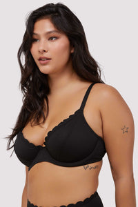 model wears black scalloped underwire bikini top with adjustable straps
