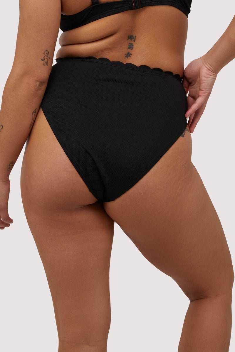 model shows full brief back of black scalloped high waist bikini bottoms