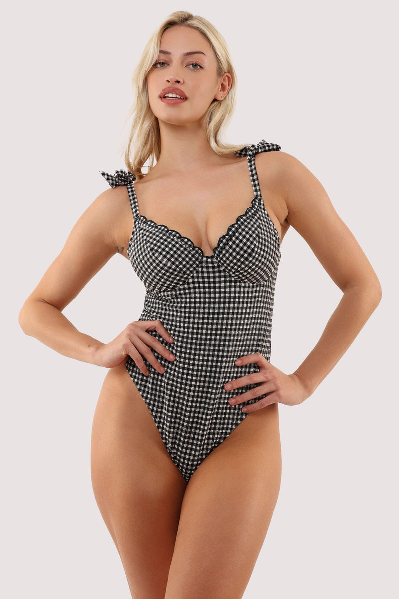 Model wears a margot black & white gingham seersucker underwire swimsuit with textured gingham fabric, supportive underwired plunge cups featuring lined gusset.
