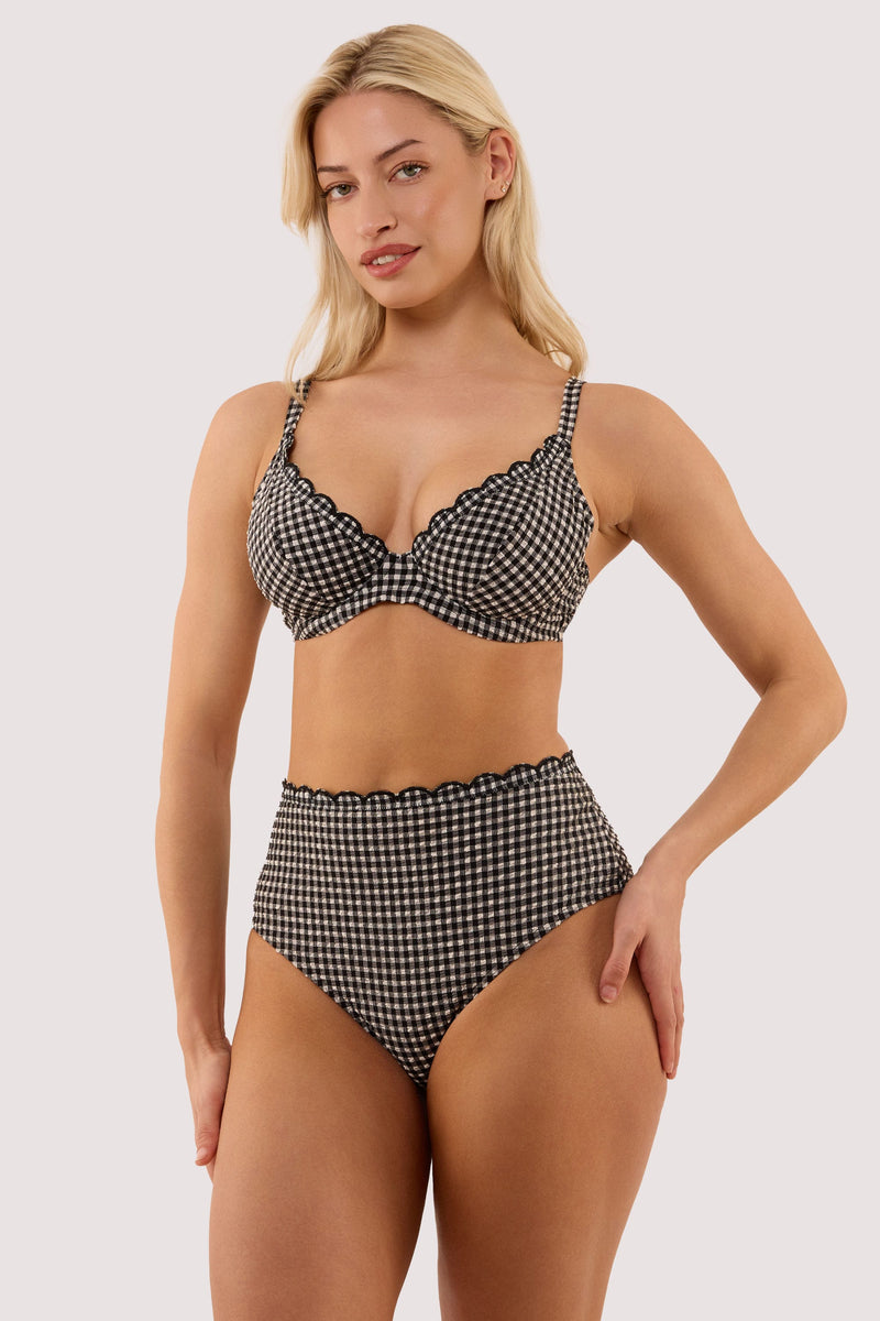 Model wears a margot black & white gingham scallop trim high waist bikini briefs with textured gingham fabric, high-waist, high-leg style with matching bikini top.