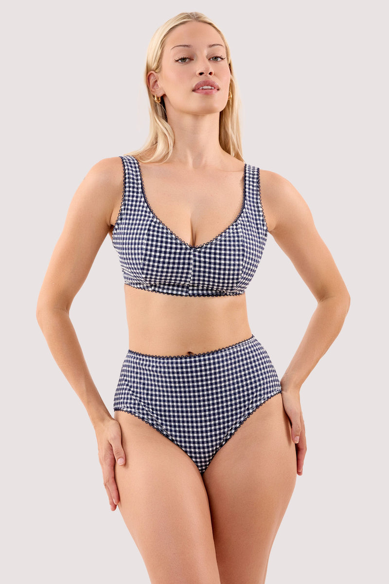 Model wears a joanna navy gingham seersucker high leg bikini brief with a matching crop bikini top.