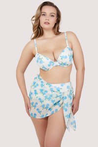 Model wears matching blue floral plunge underwire bikini top, high waist bikini bottoms and sheer tie waist sarong set