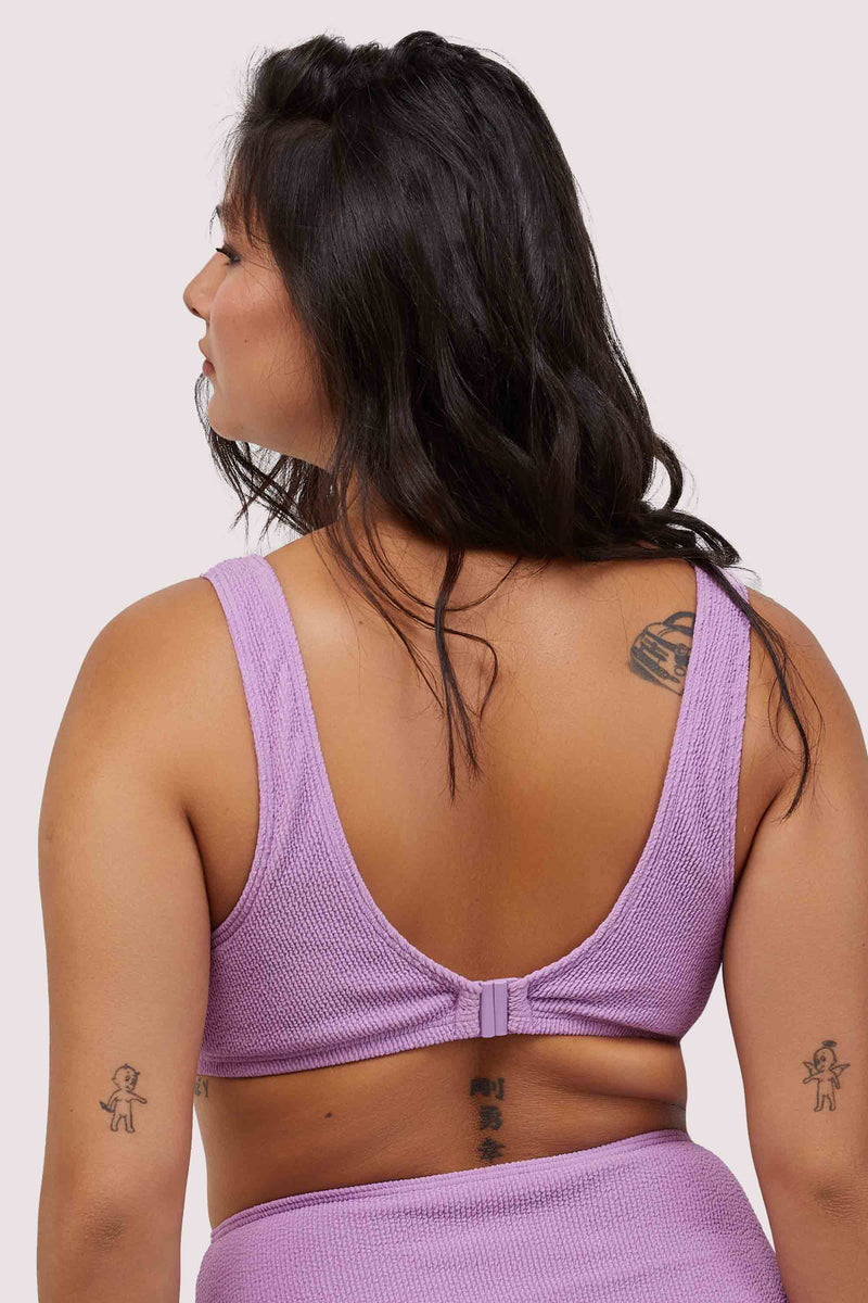 model shows hook and eye fastening back of lilac scrunch fabric bikini top with thick shoulder straps