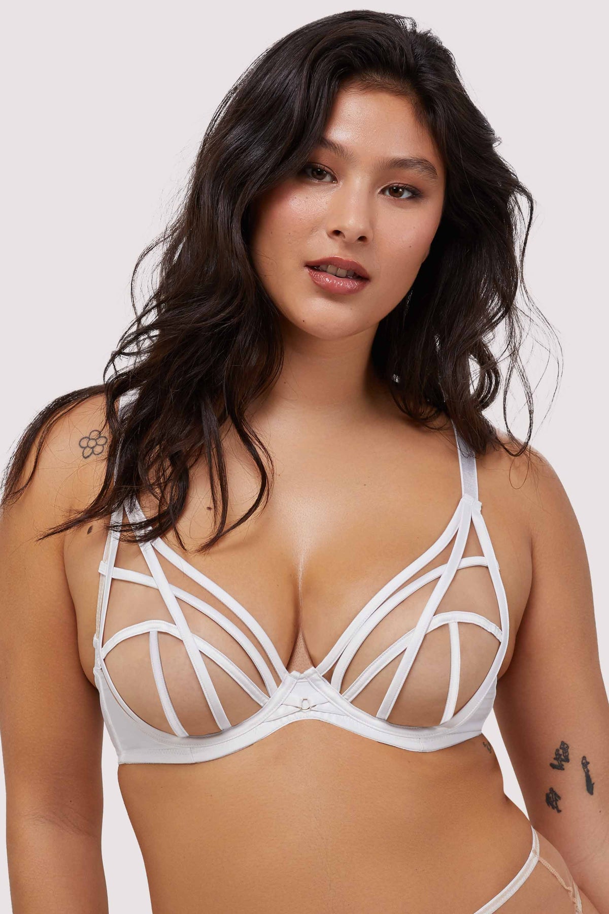 Model wears white strap detail and mesh plunge bra