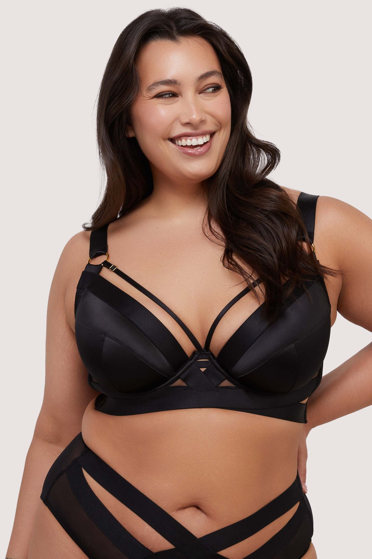 model wears black satin plunge bra with straps