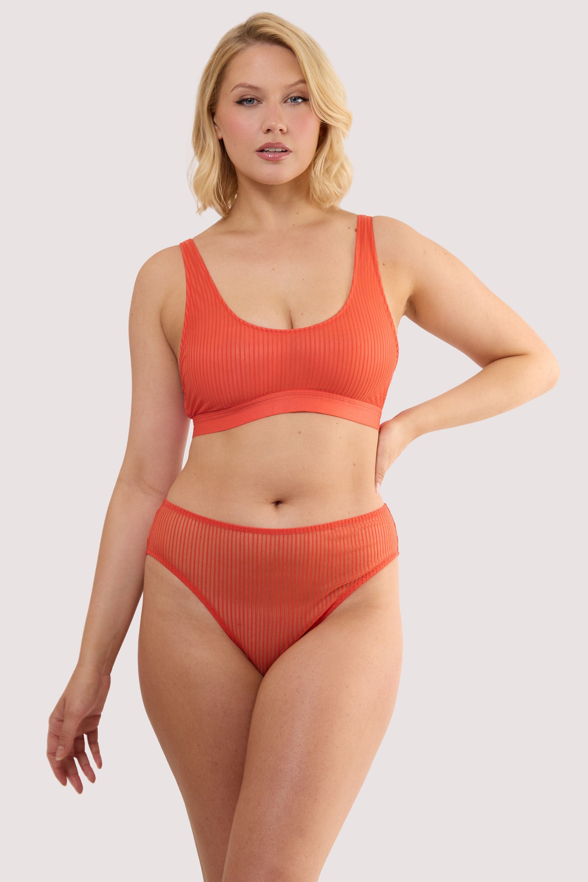 Model wears a veronica red microstripe hipster brief with red microstripe stretch mesh with matching microstripe crop bra.