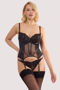 Model wears a samara black leatherette & lace basque with leatherette and lace panelling, adjustable shoulder and suspender straps with a matching thong.