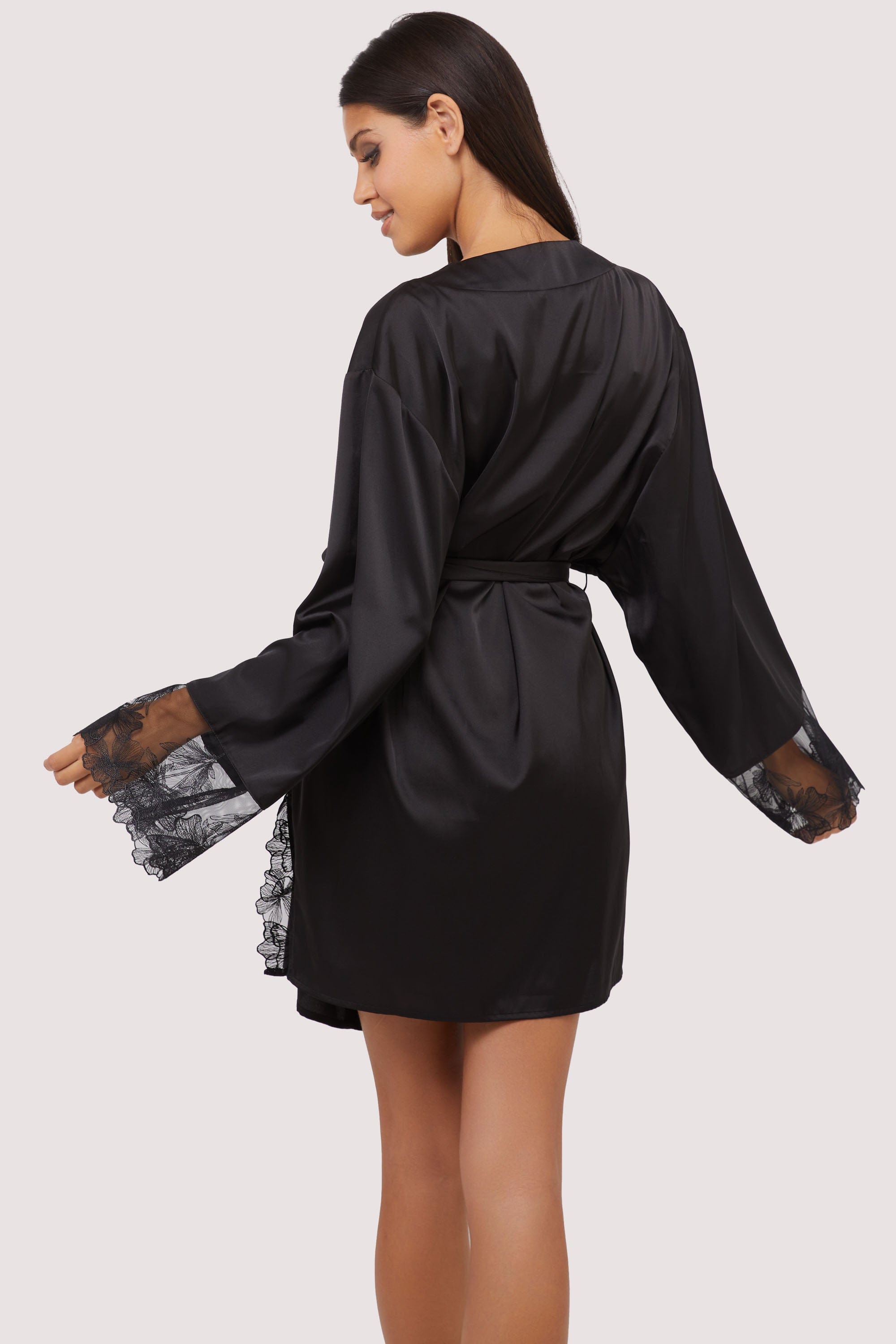 Model wears sexy black satin tie waist robe with embroidered lace trim