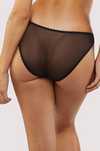Model Back view of mesh black Briefs featuring sheer mesh panels, soft black edging, and a flattering mid-rise fit.