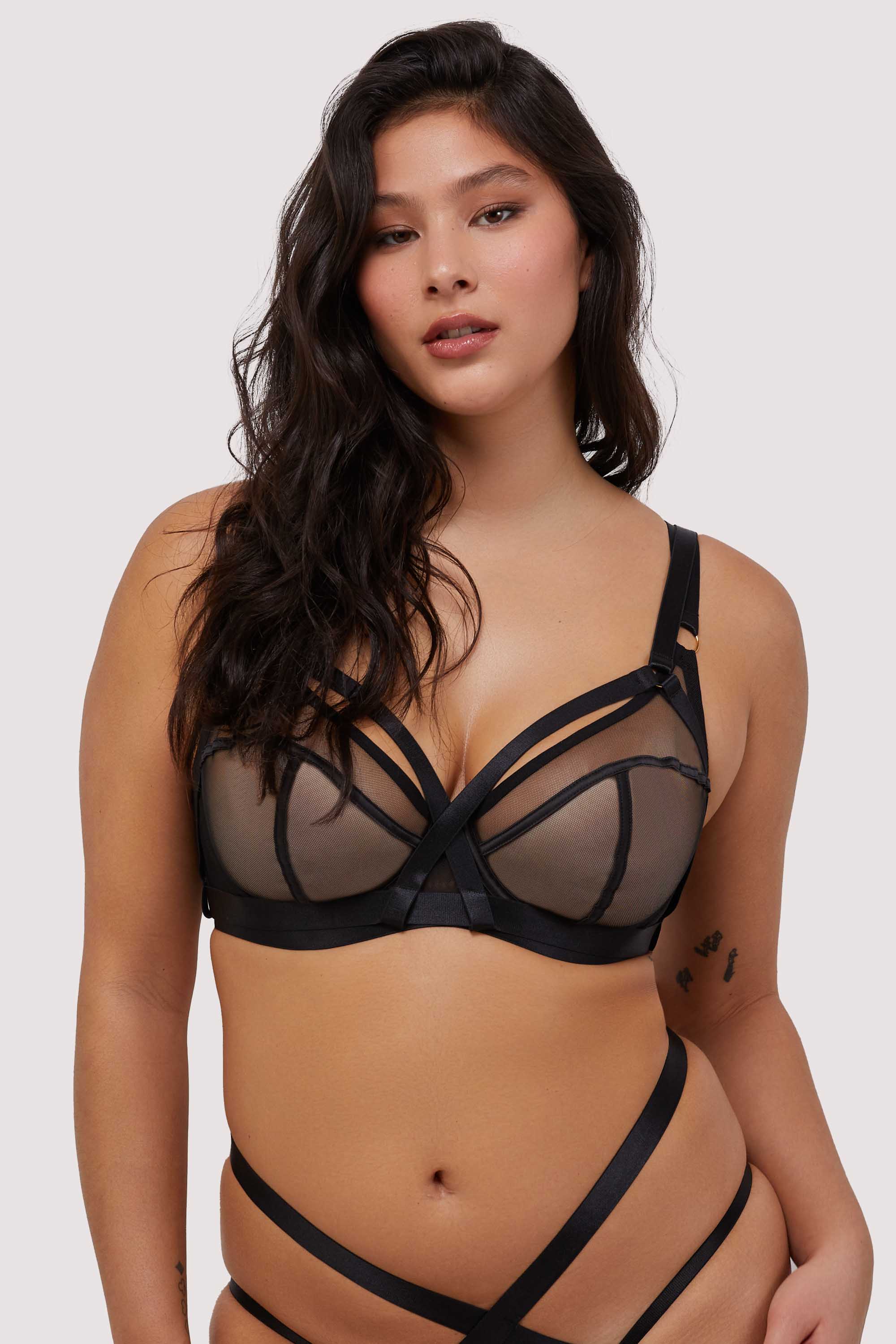 Model wears black mesh balcony bra with harness straps