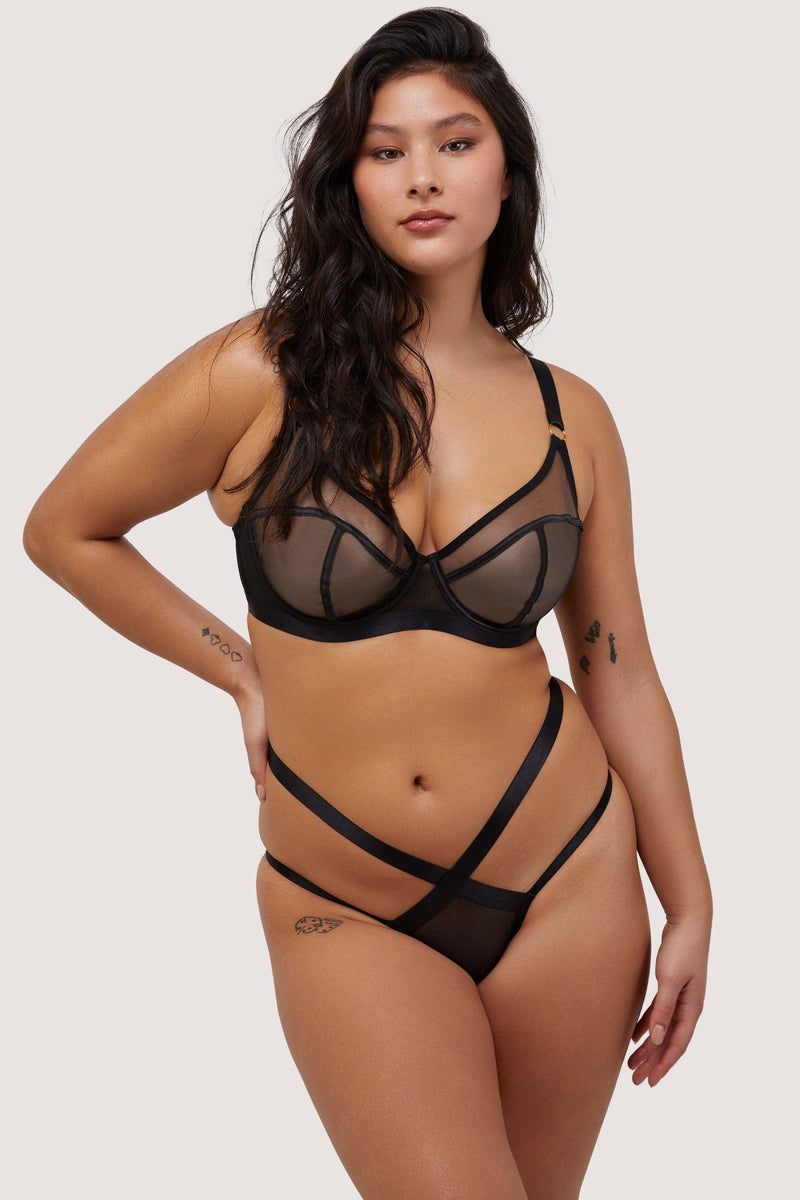 Model wears black balcony bra with matching Brazilian brief lingerie set