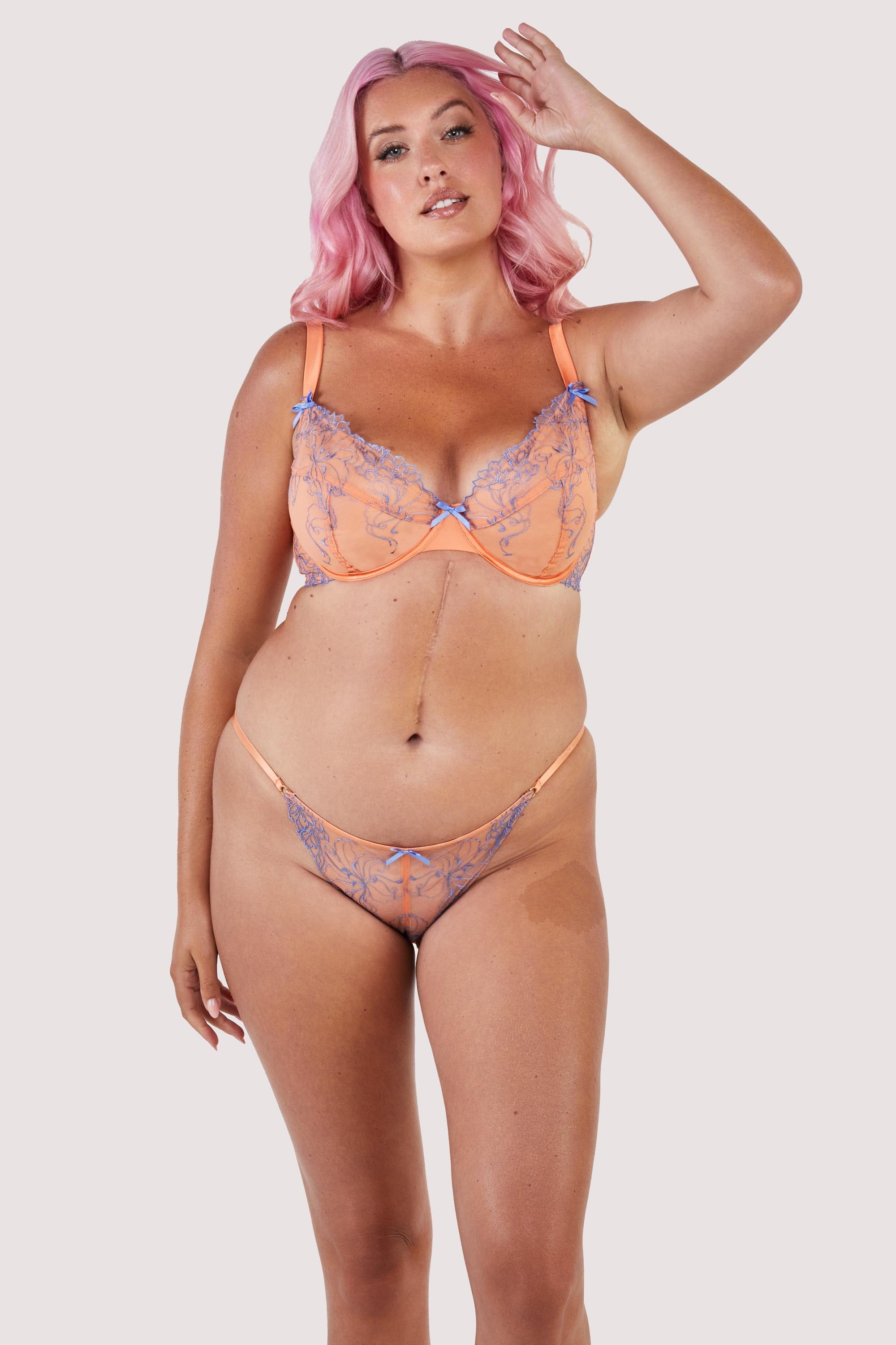 Orange mesh bra with blue-lilac embroidery and bows, with matching tanga brief.