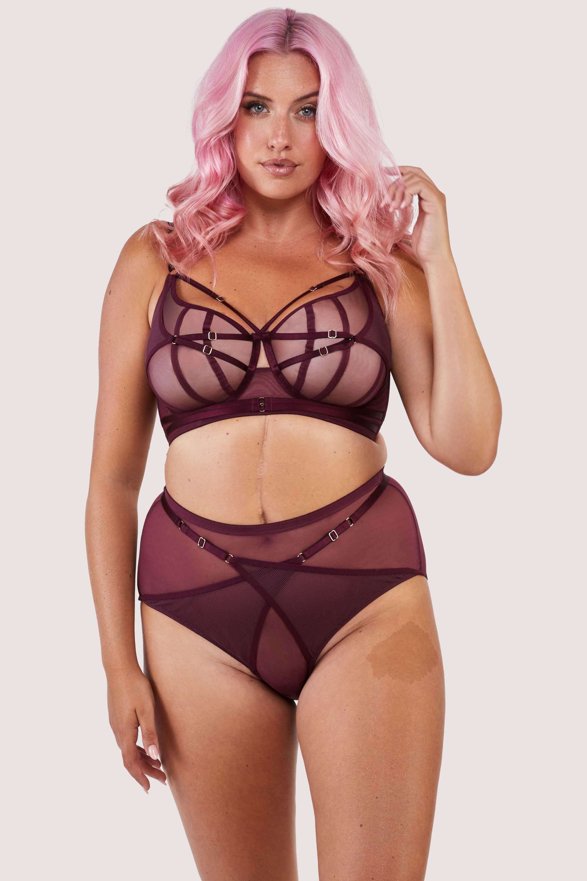 Dark purple-red mesh bra with strap detailing over the bust and visible gold hardware. Paired with matching brief.