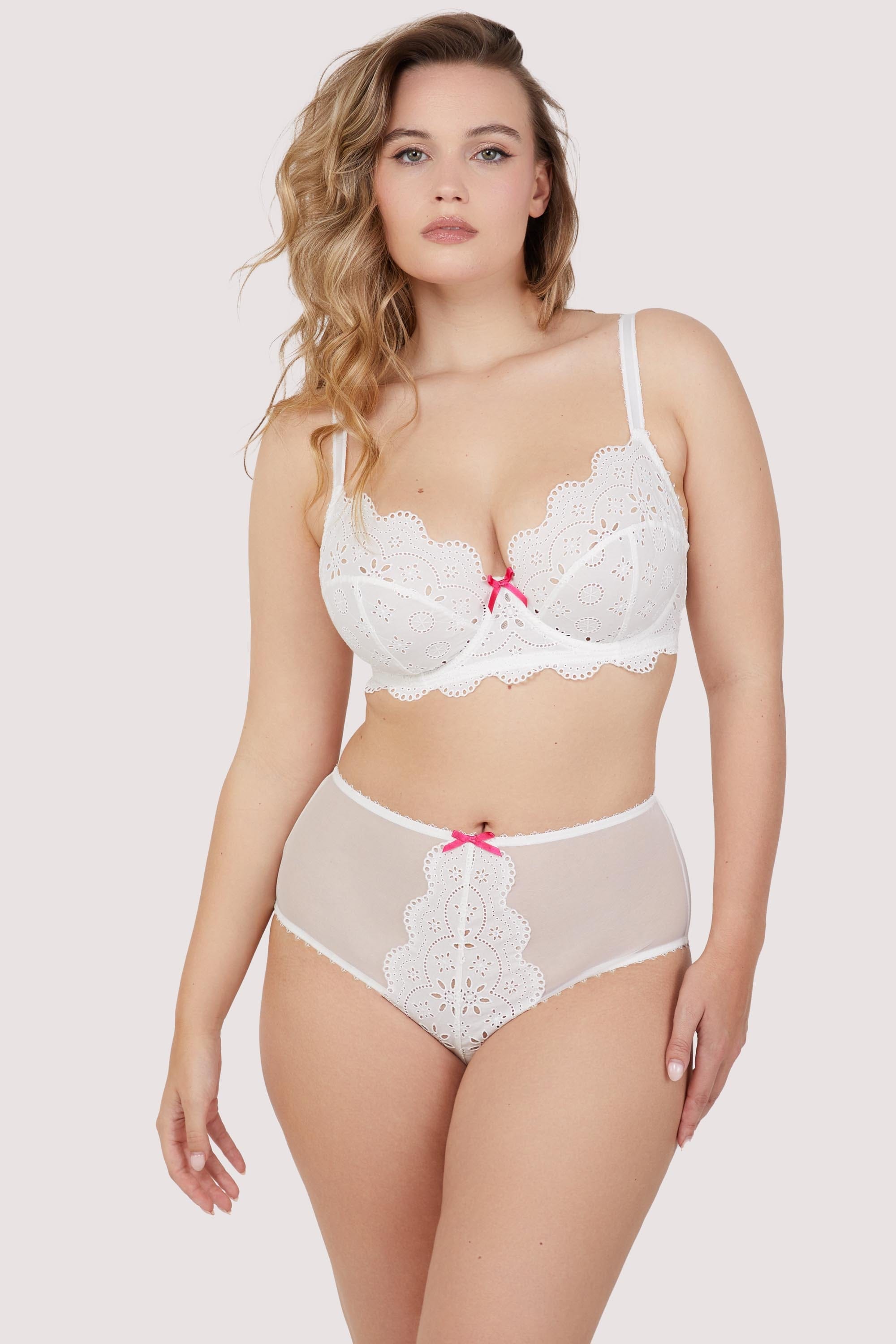 Model wears white broderie anglaise and mesh lingerie set