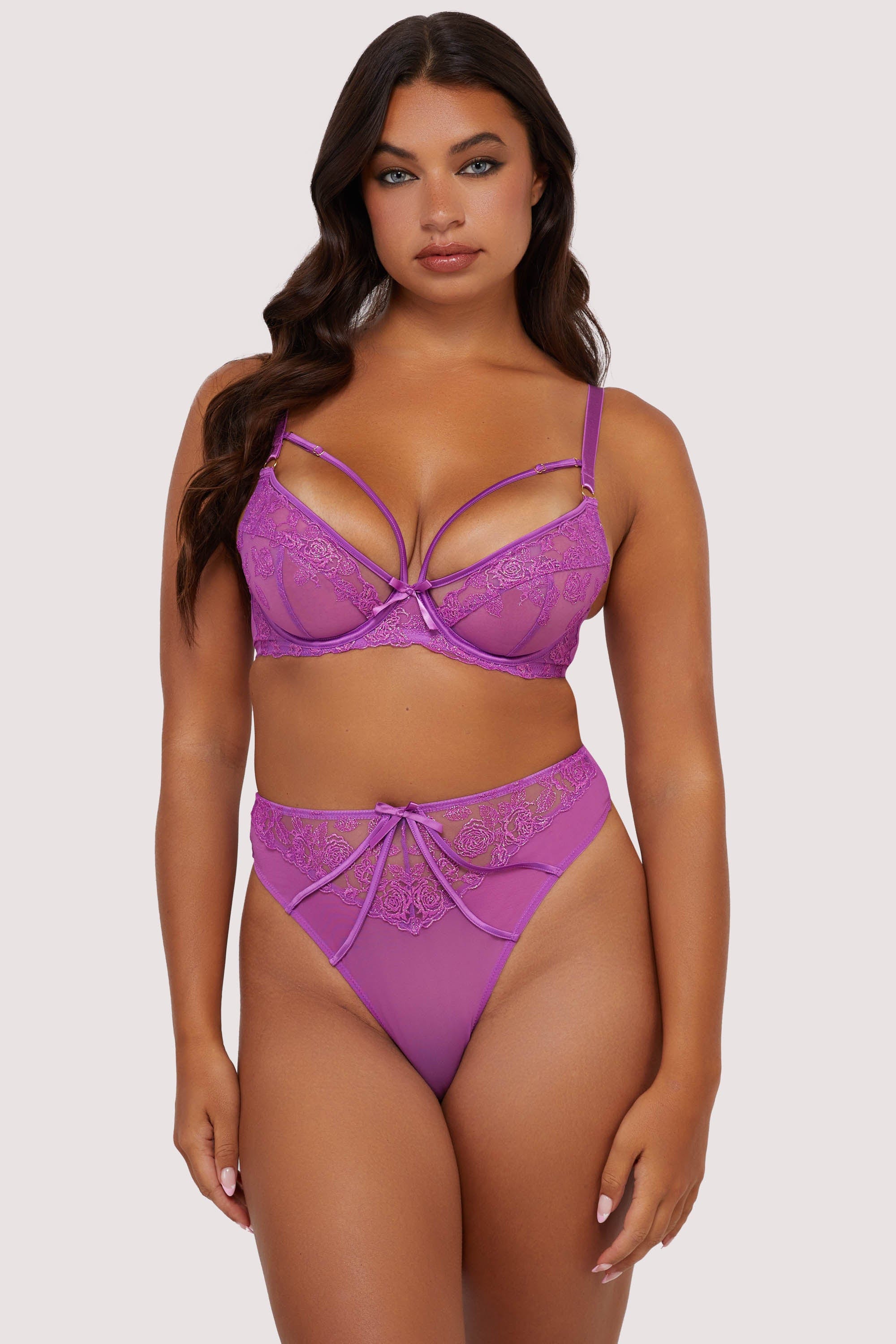 Model wears purple strappy lace plunge bra and high waist thong lingerie set