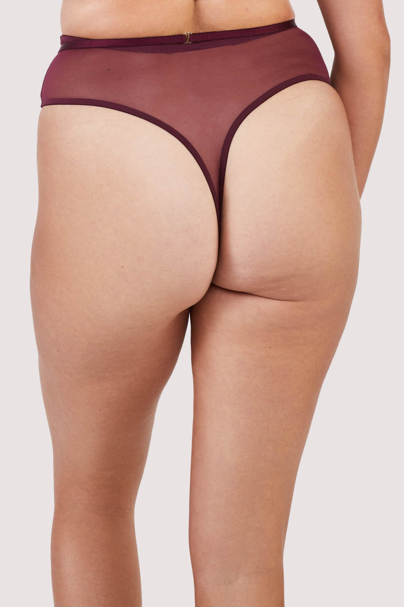 Back view of a dark purple-red mesh thong with visible gold hardwear and crossover panelling across the front.