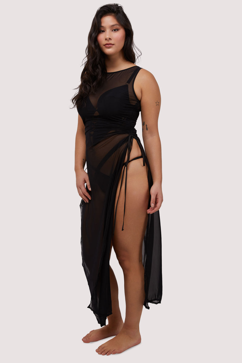 Model wears sexy sheer black mesh long dress with deep side splits