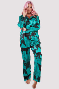 Green satin pyjamas with a pocket on the breast, in a black panther and leaf print design.