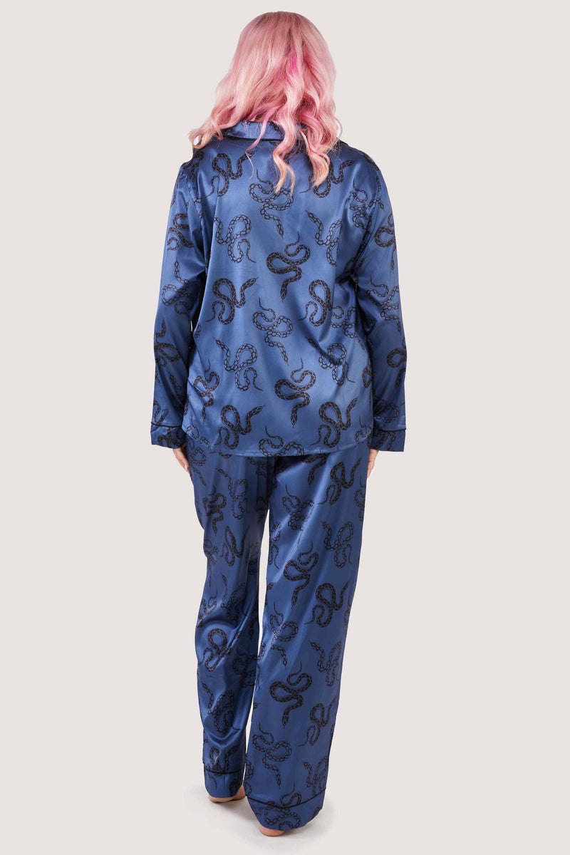 Back view of blue satin pyjamas with a pocket on the breast, in a black snake print design.