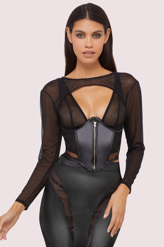 Model wears a black shrug with super cropped long sleeve bolero, with a matching underbust corset and pencil skirt.
