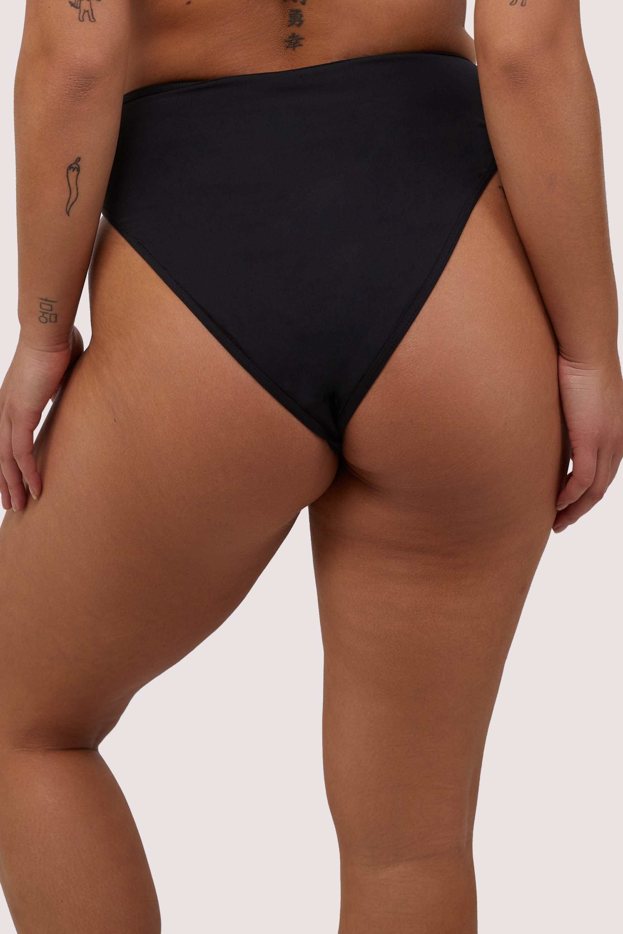 model shows full brief back of high-waist and high-leg bikini bottoms