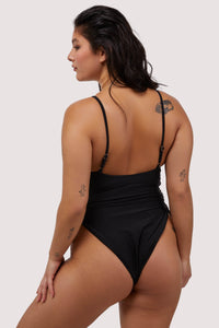 Model shows black swimsuit low back and adjustable shoulder straps