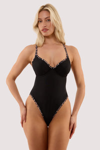 Model wears a lorna leopard print fuller bust underwired swimsuit with underwire cup featuring leopard print trim.