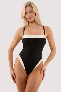 Model wears a ally black & ivory bandeau swimsuit with ivory contrast trim.