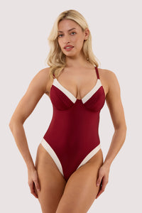 Model wears a stasia wine and ivory fuller bust underwired swimsuit with ivory contrast trim, high Leg, full style brief, featuring lined gusset.