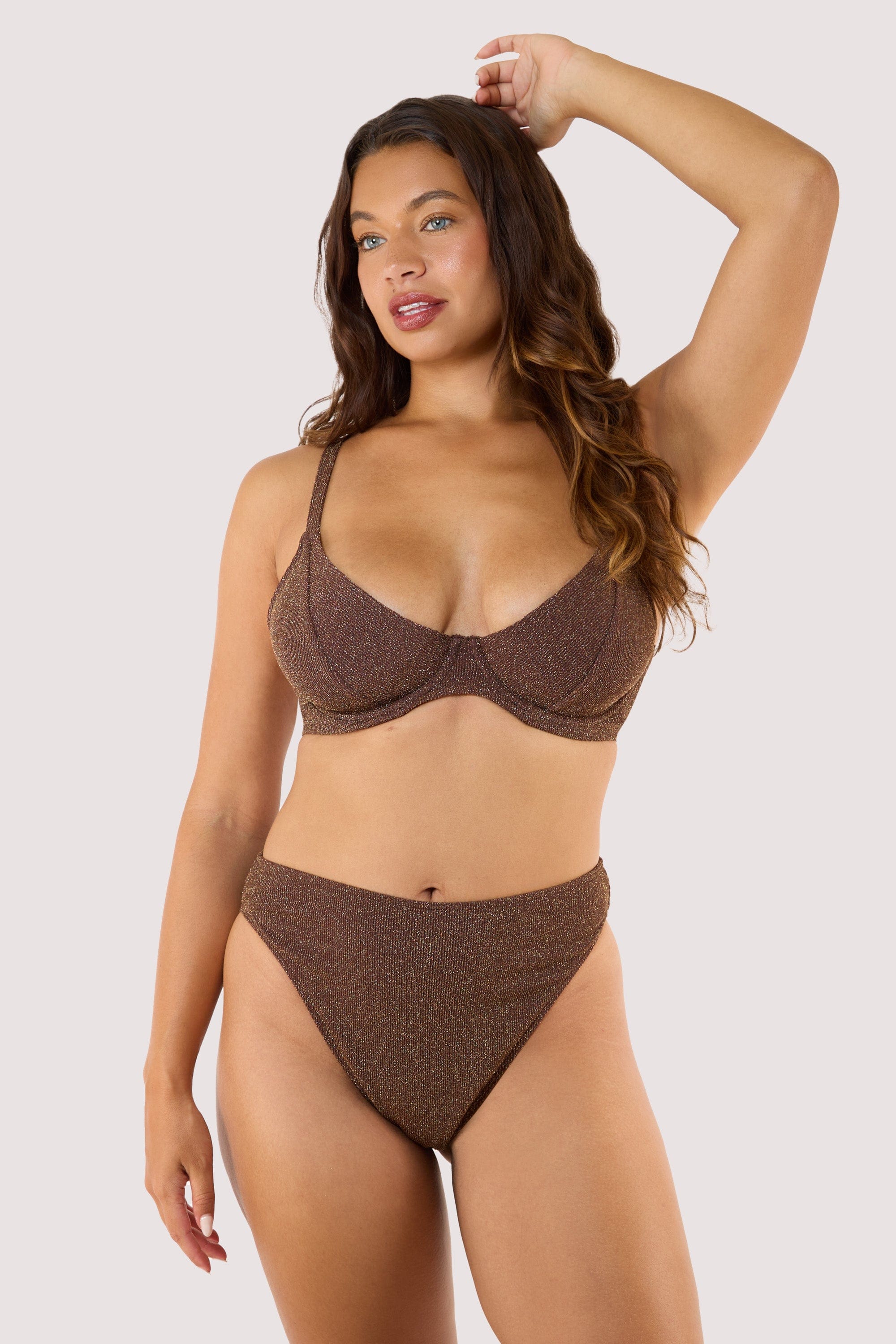 Model Front view of underwire bikini top with matching high-leg bottoms in shimmering bronze fabric.