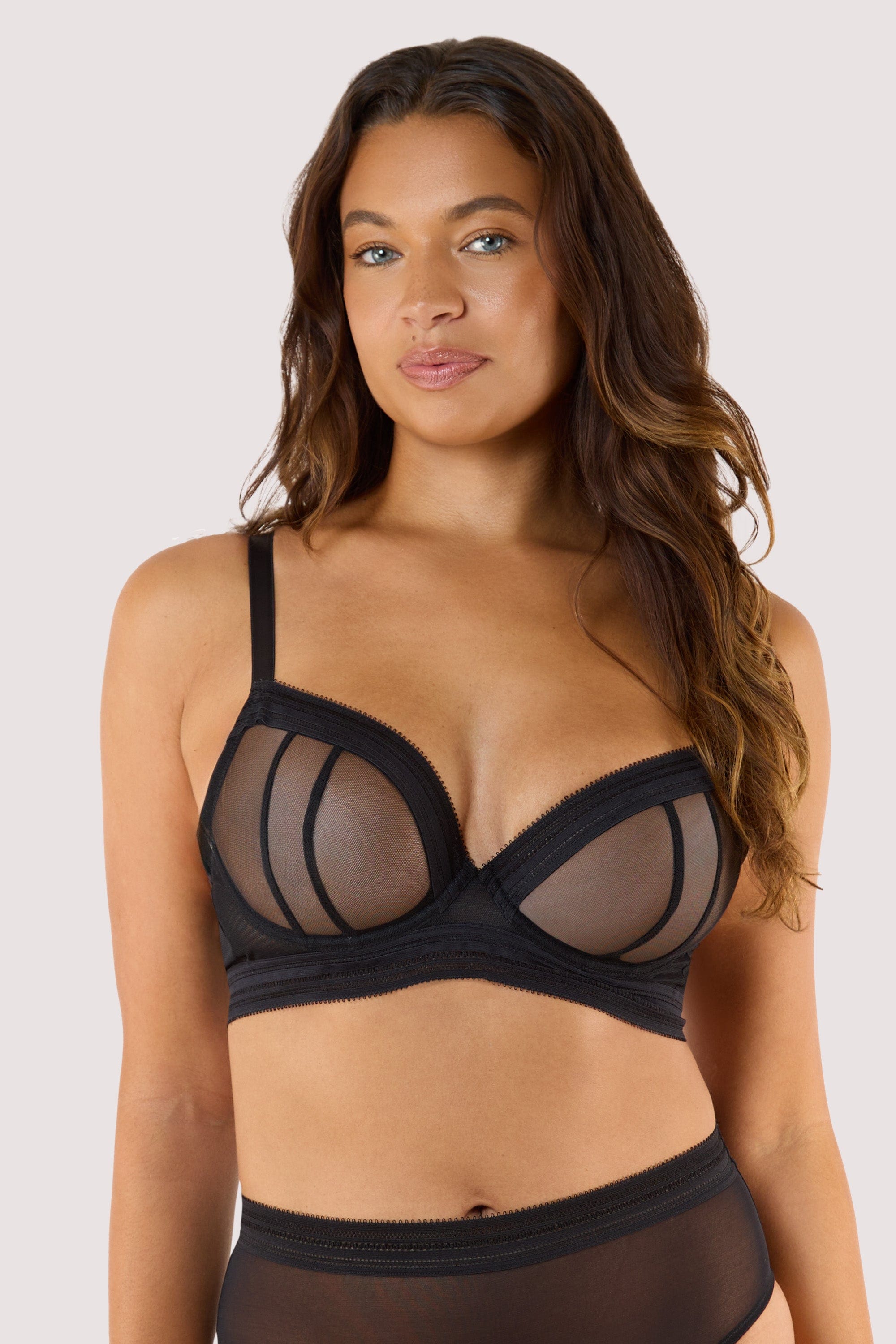 Model wears black sheer plunge bra with sheer mesh plunge cups longline underband