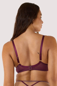 Model shows the back of a wine plunge bra with hook and eye closure, with adjustable straps.