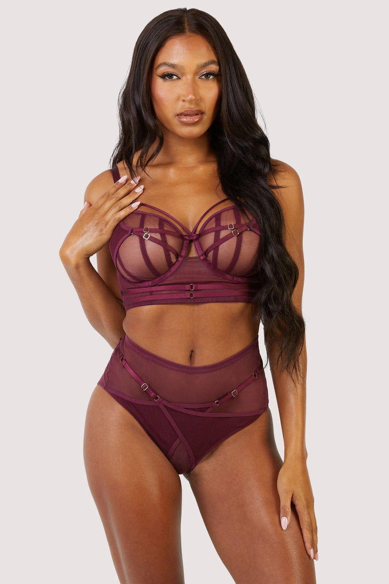 Dark purple-red mesh bra with strap detailing over the bust and visible gold hardware. Paired with matching brief.