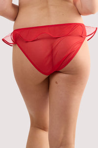 Model wears a monica red ribbon slot lace brief with sheer mesh with scalloped lace and red ribbon slot detailing with satin rose, with a matching bra.