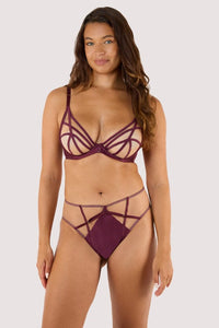Model wears a wine high waist brief featuring a satin central panel, strap detailing, and gold metal hardware, with a matching wine plunge Bra.