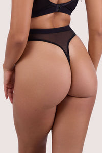 Model shows back of black mesh high waist thong with sheer fabric and elastic waistband