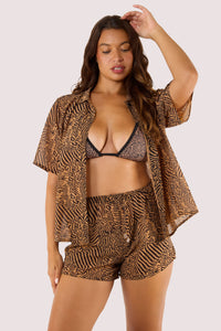 Model wearing tiger print georgette co-ord set with drawstring shorts and open shirt.