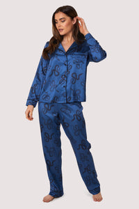 Blue satin pyjamas with a pocket on the breast, in a black snake print design.