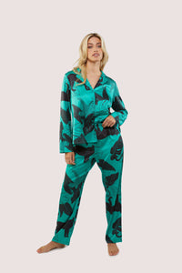 Green satin pyjamas with a pocket on the breast, in a black panther and leaf print design.