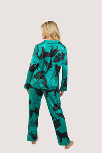 Back view of a green satin pyjamas with a pocket on the breast, in a black panther and leaf print design.